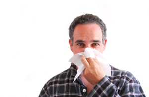 Man with a flu blowing his nose