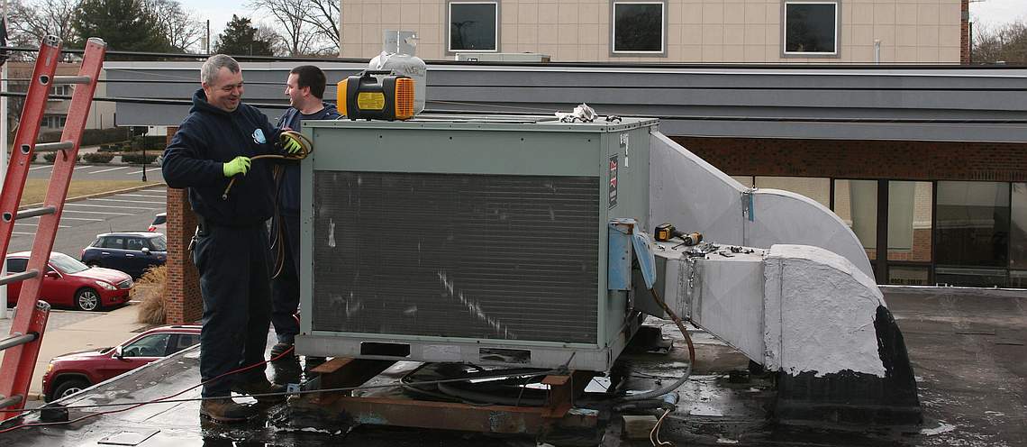 Cranbury Comfort team installing a new Commercial HVAC System on a bank rooftop